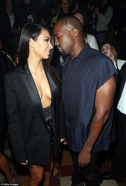 Kim Kardashian appears topless under open tuxedo jacket  